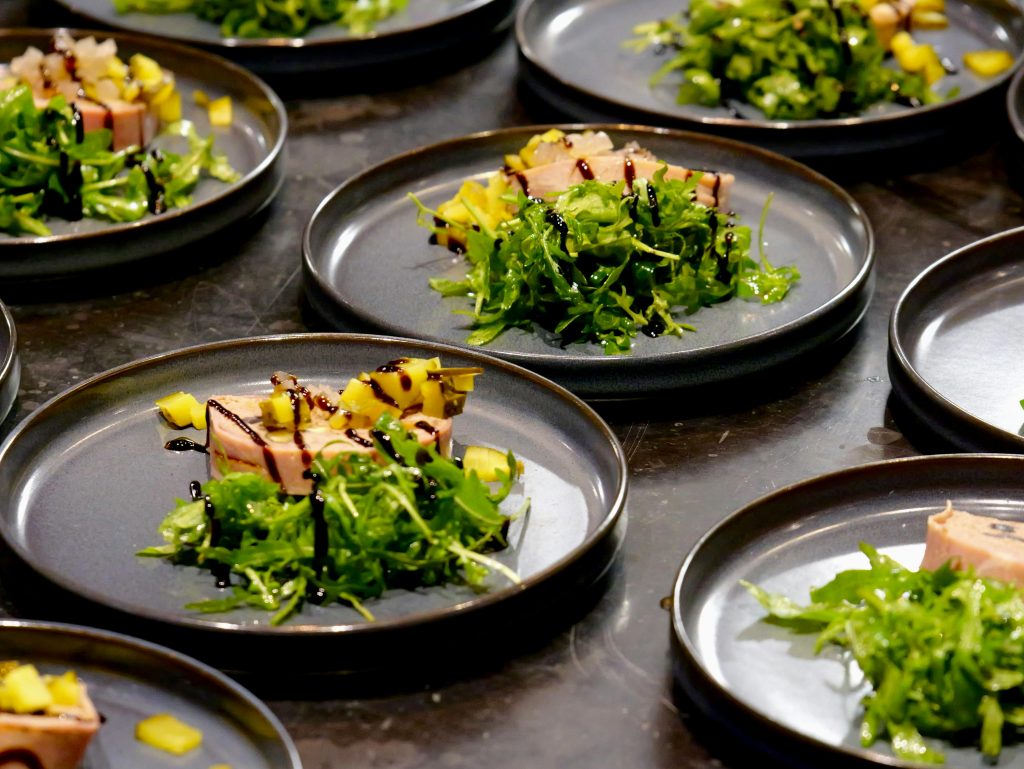 pexels-photo-29546572-29546572 Elegant gourmet dish carefully plated with arugula, mango, and balsamic glaze.